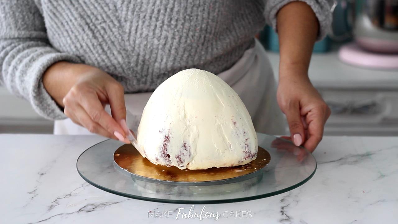 smoothing mushroom cake top with acetate