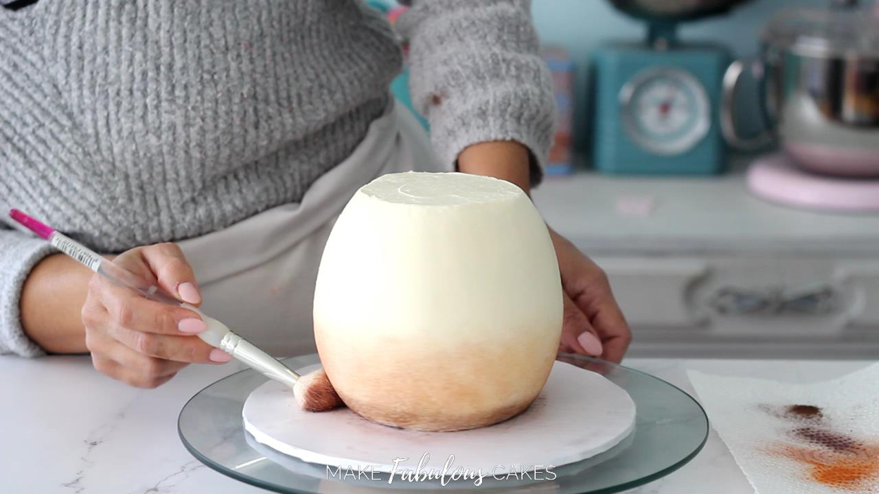 brushing brown powder food color on mushroom cake