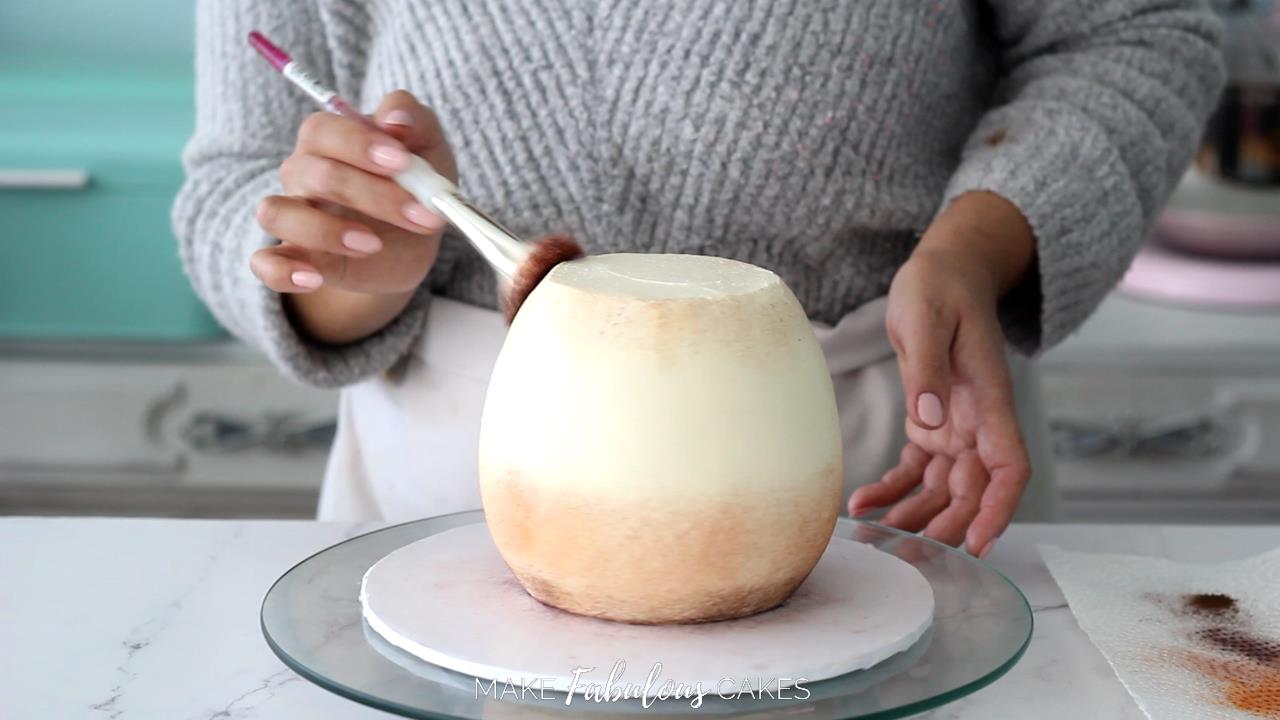 brushing brown powder food color on mushroom cake