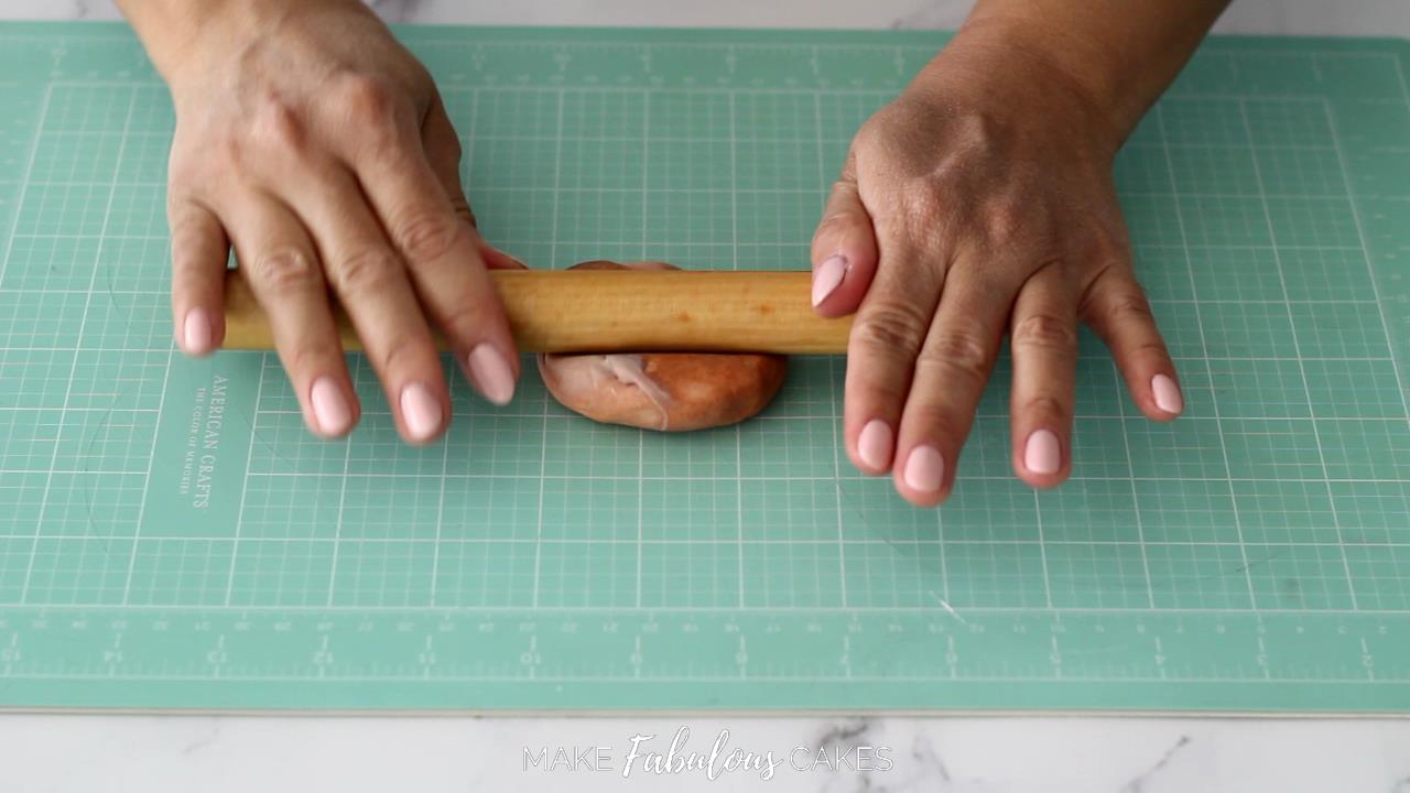 rolling brown fondant with small rolling pin