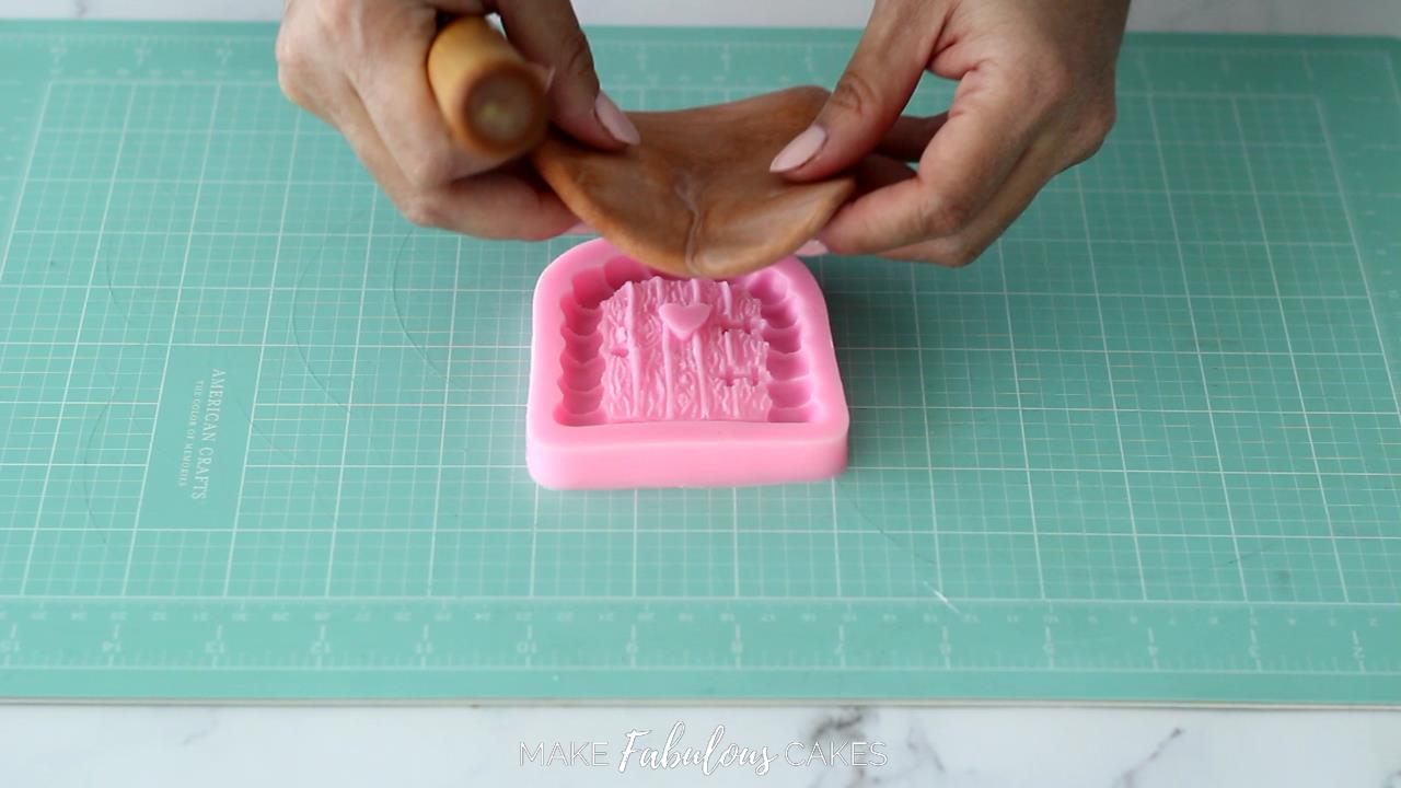 placing the brown fondant over door silicone mold