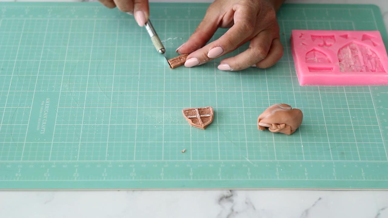 making windows for mushroom cake using mold and brown fondant