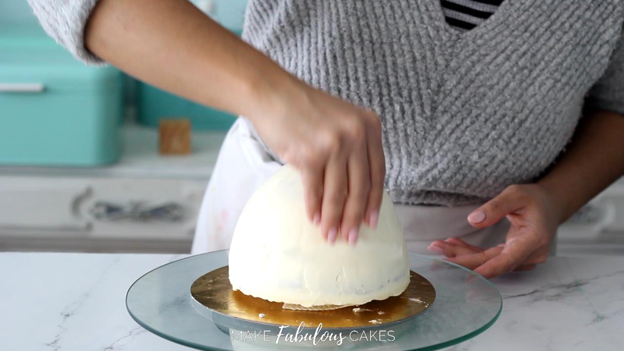 smoothing mushroom cake top with acetate